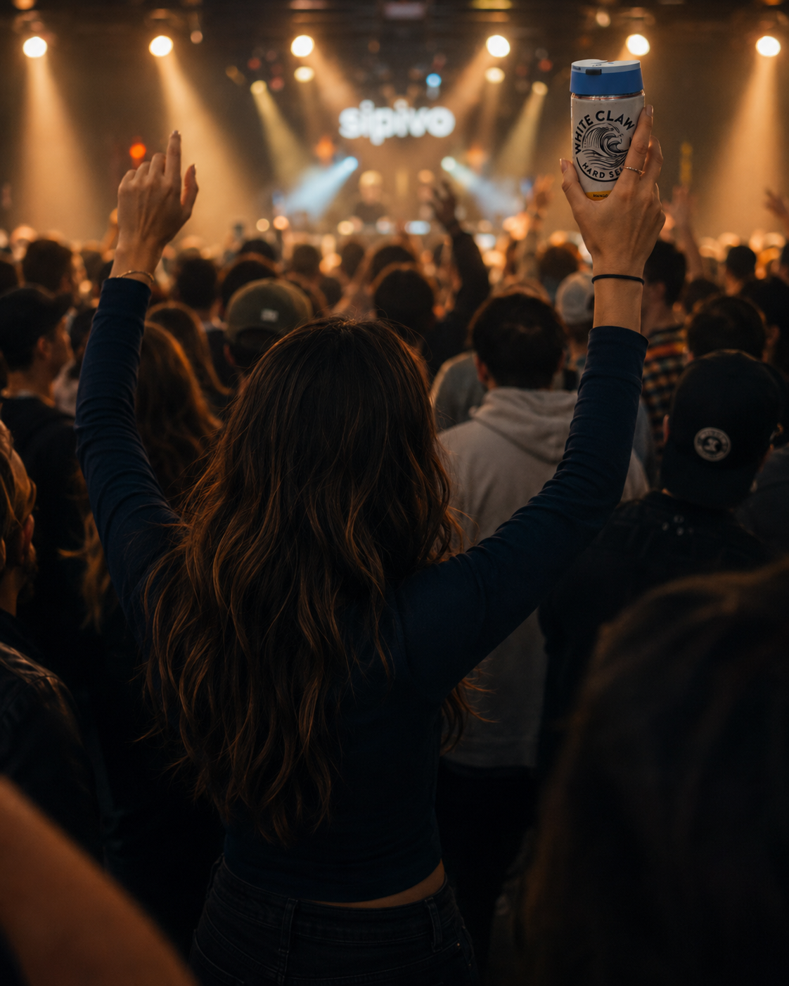 Person at a concert holding a can with a Sipivo sip safe guard on